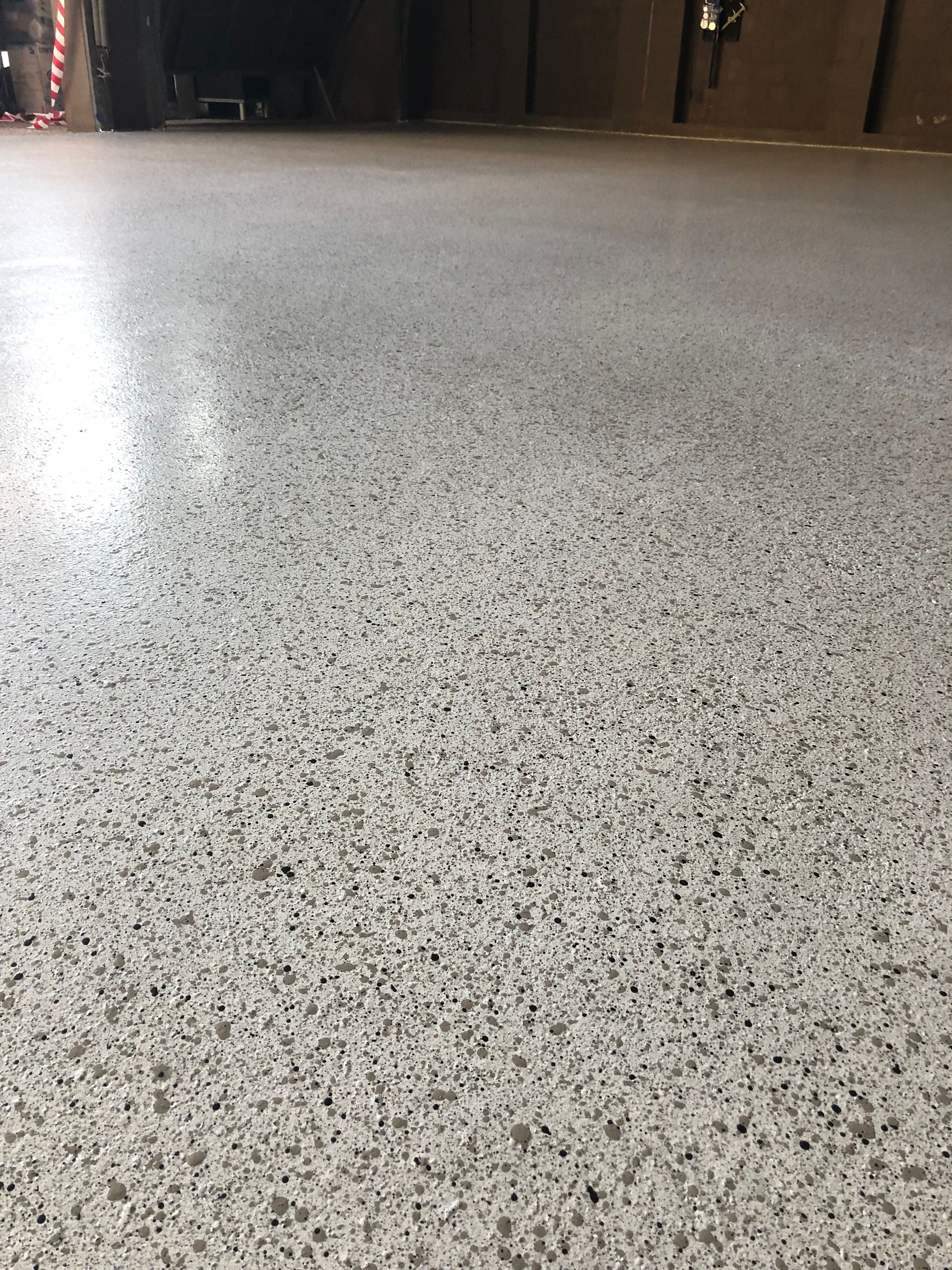 Premium Dulux Avista epoxy flooring in Stippled Stone finish, professionally installed for a local OAM recipient in Aspendale by Melbourne Concrete Sealing .
