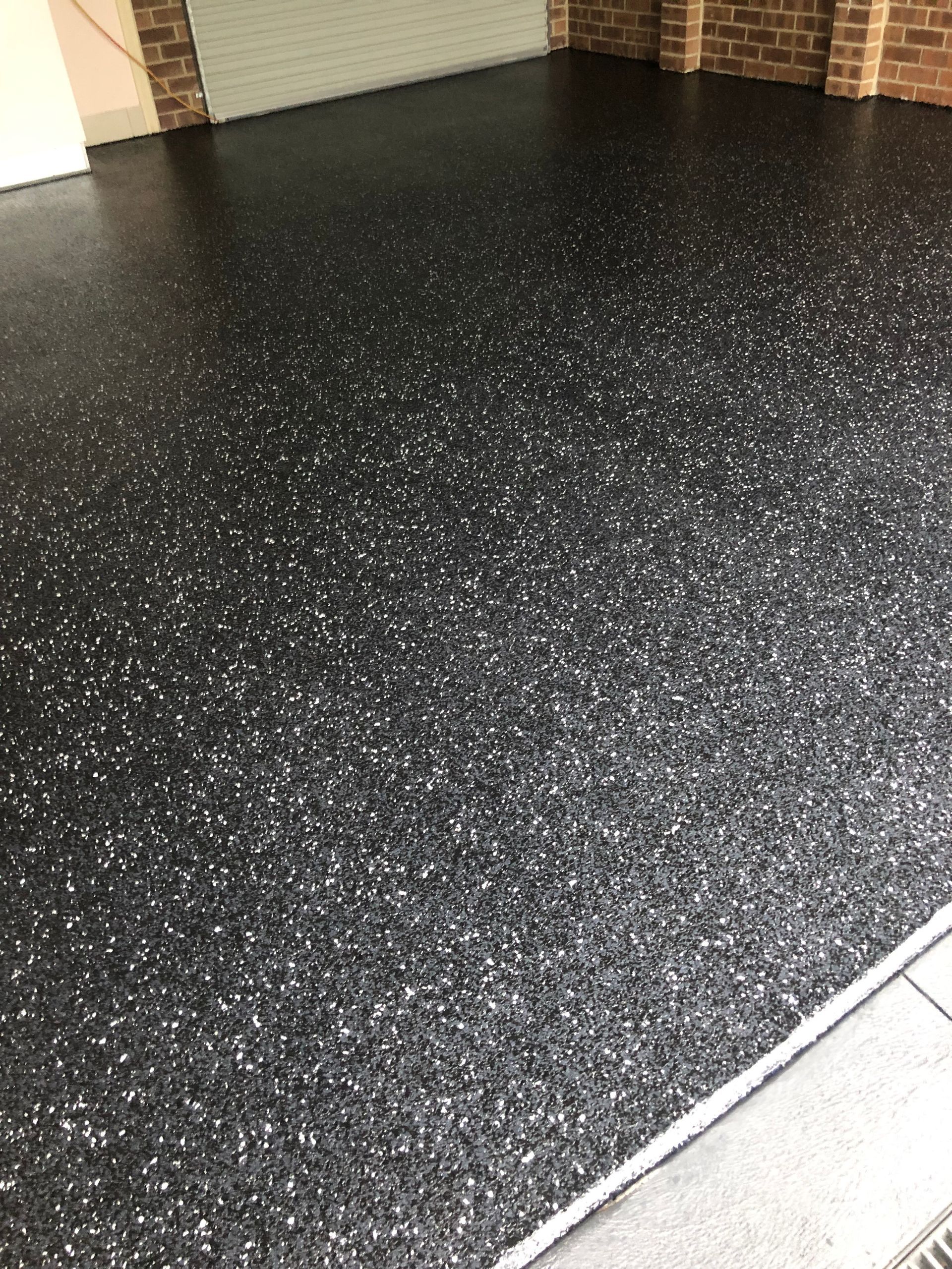 Professional epoxy flake flooring installation featuring Durable Concrete Coatings in a residential garage, completed by Melbourne Concrete Sealing and Resurfacing in the South East