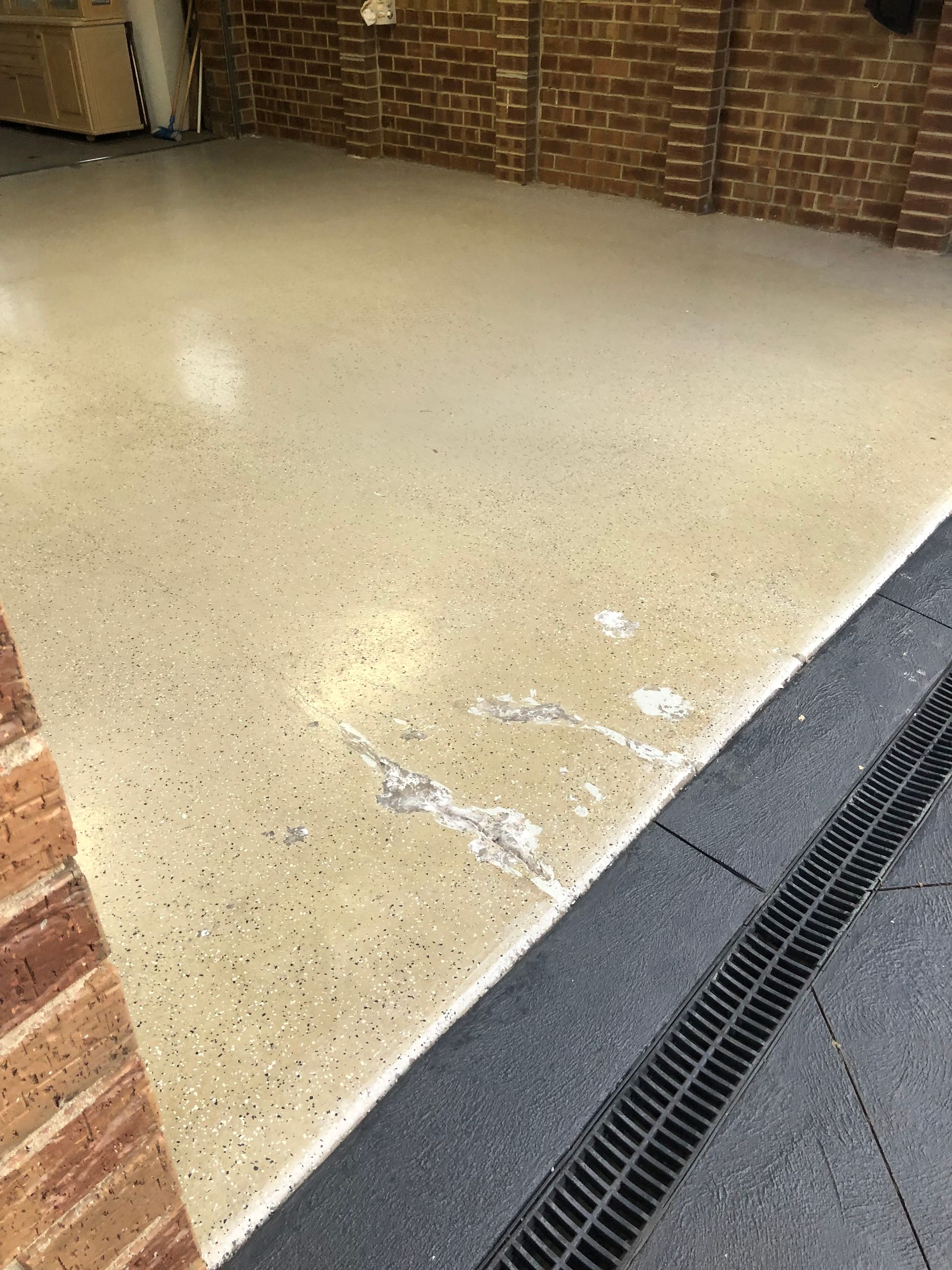 Worn garage concrete floor before Signature Stunning Epoxy System installation in Aspendale by Melbourne Concrete Sealing and Resurfacing.