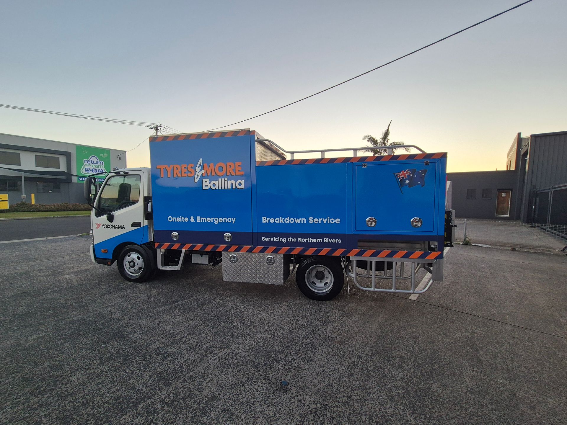 Blue cargo truck parked on a gravel lot at sunset- — Ballina Tyrepro in Ballina, NSW