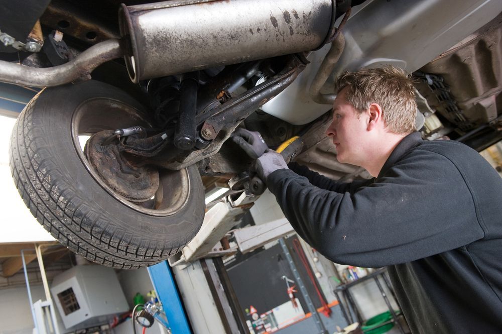 Mechanic Working Under a Lifted Vehicle — Ballina Tyrepro in Evans Head, NSW