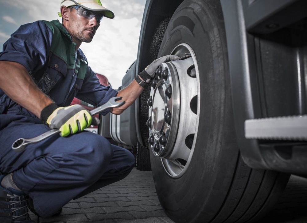 Man Holding Spanner In Hand And Taking Look At The Wheel — Ballina Tyrepro in Ballina, NSW