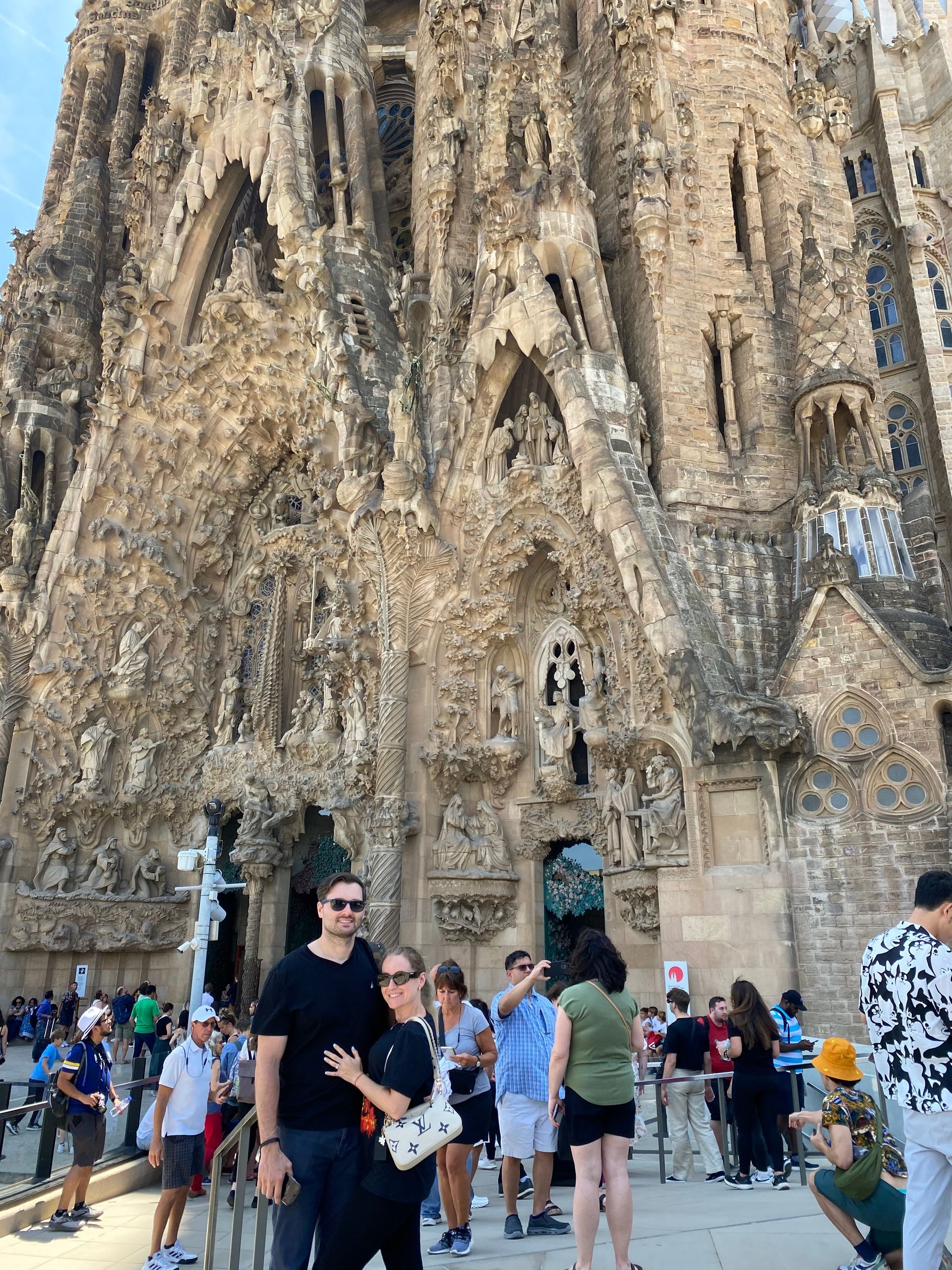 Crowd in front of the Sagrada Família’s ornate stone façade in Barcelona.