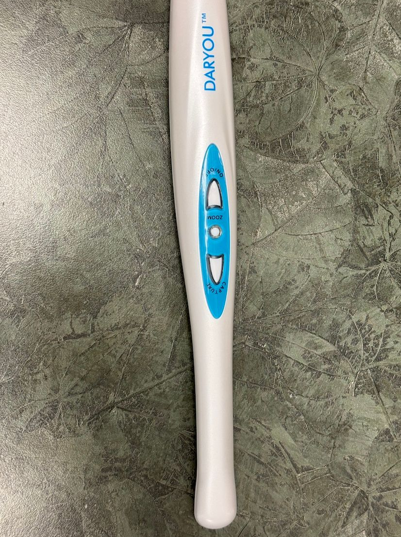 White and blue digital thermometer on a gray marble surface