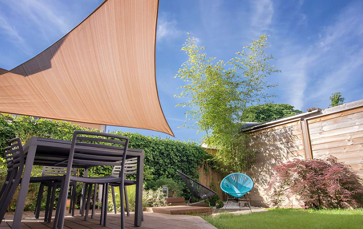 Inside a small wooden shed, open doors frame a bright outdoor construction site.