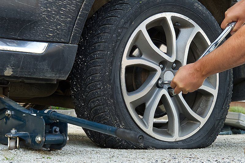 Person Changing The Car Tire
