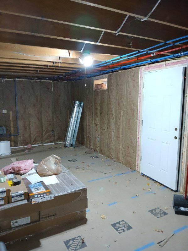 A room with a lot of boxes on the floor and a door.