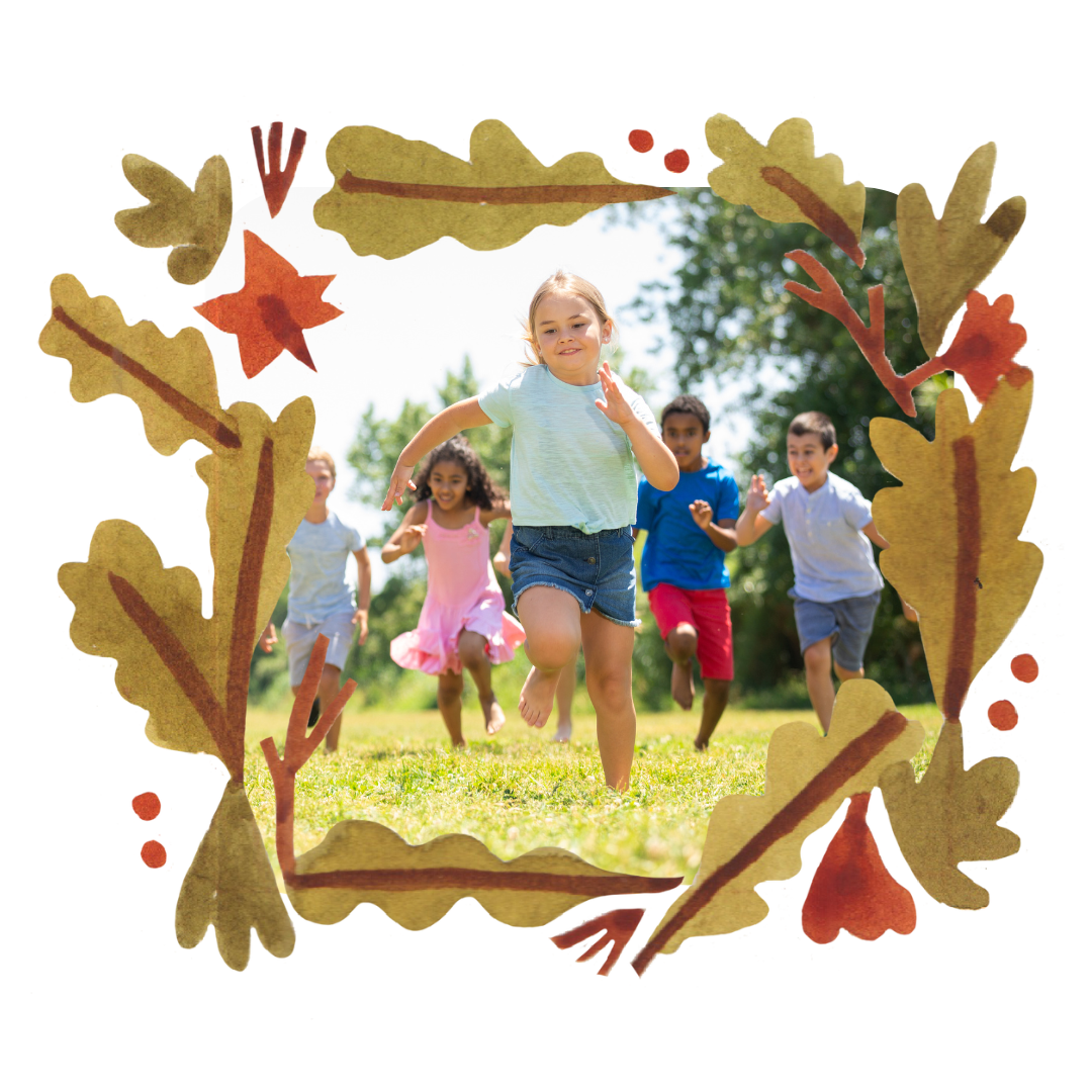 A group of children are running in a field surrounded by leaves.