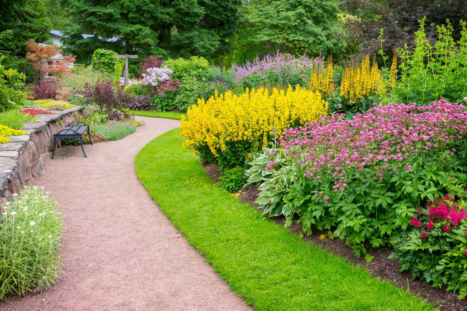 Garden With Lot Of Plants And Water | Gilberts, IL | Crown Tree Care Inc.
