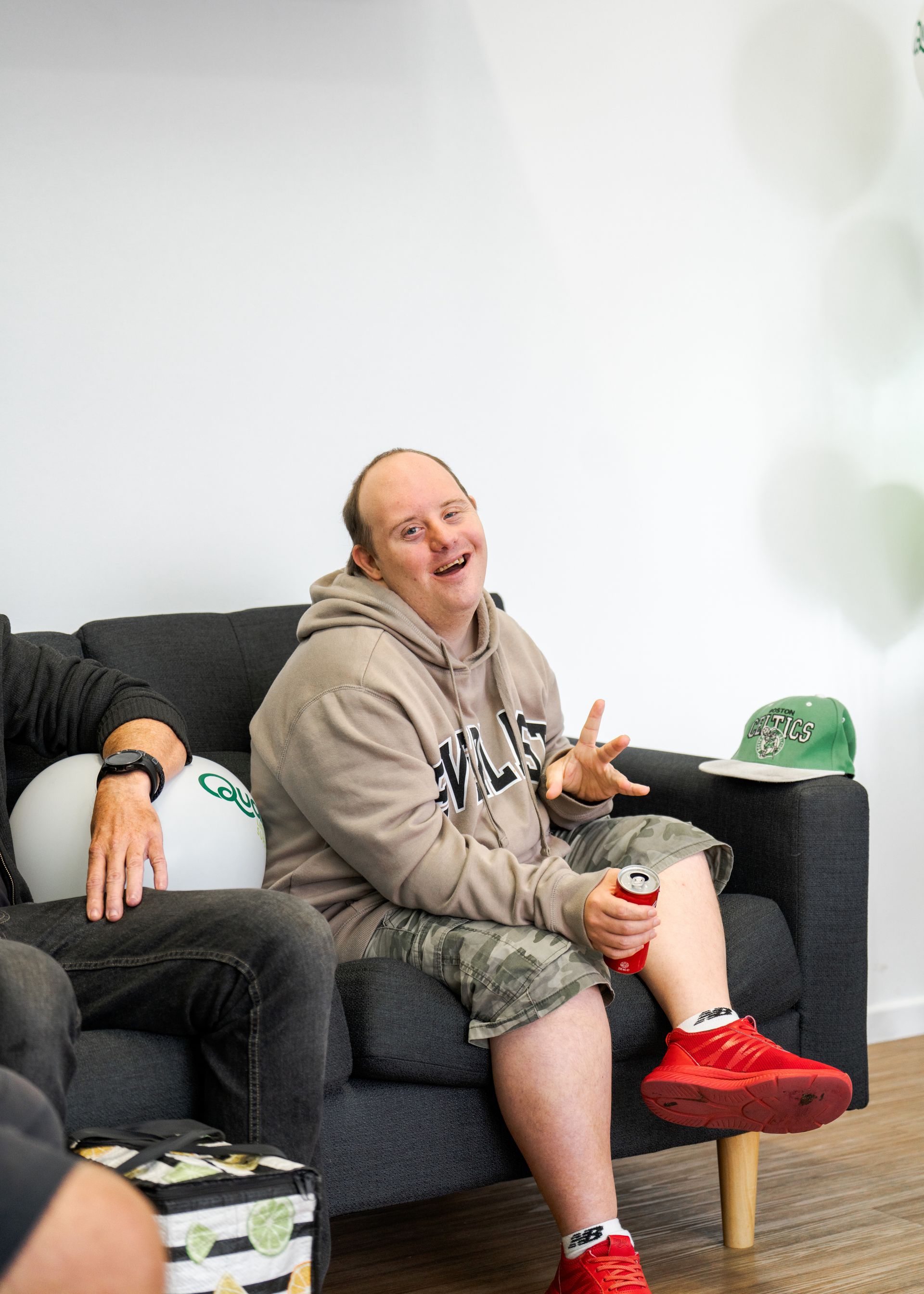 Support worker with two male clients in a pergola in the park