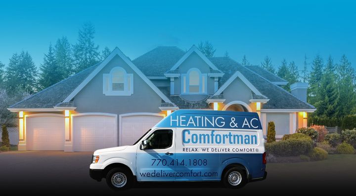 Comfortman service van with contact info and slogan