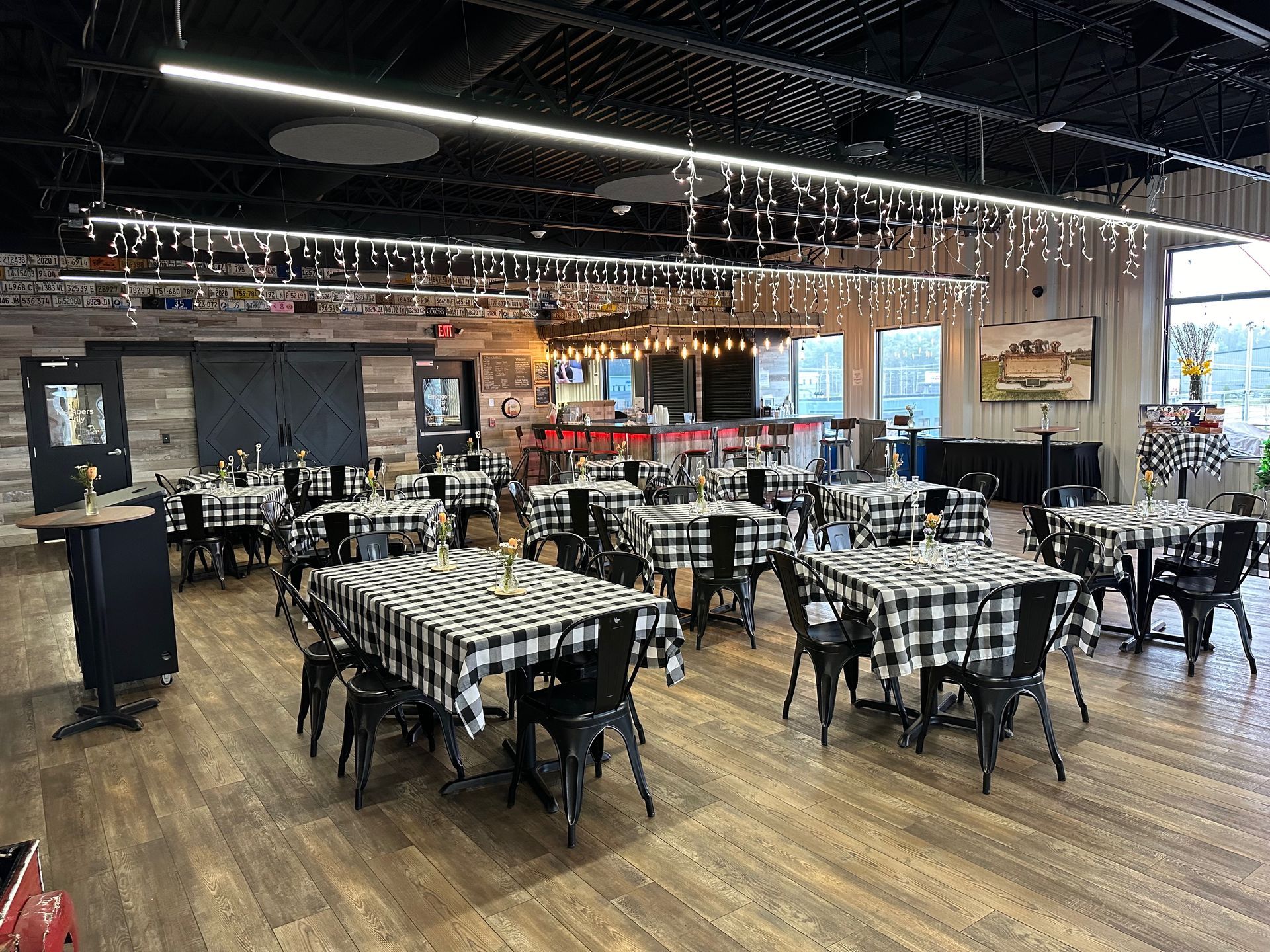 A large room filled with tables and chairs in a restaurant.