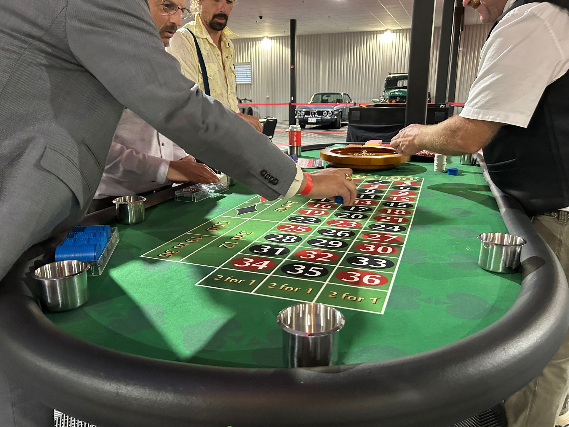 A group of men are playing roulette at a casino table.