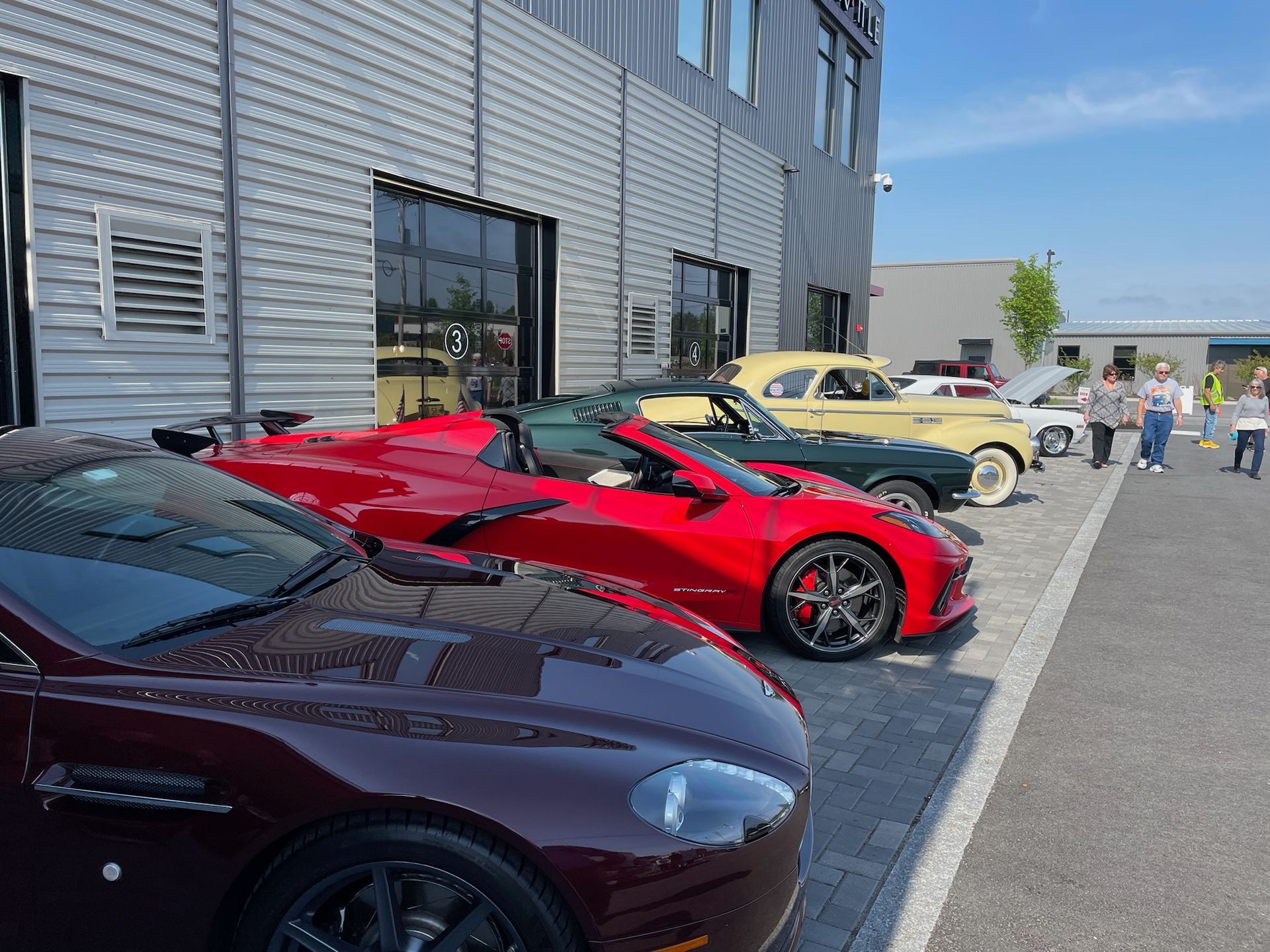 A group of cars are parked in front of a building.