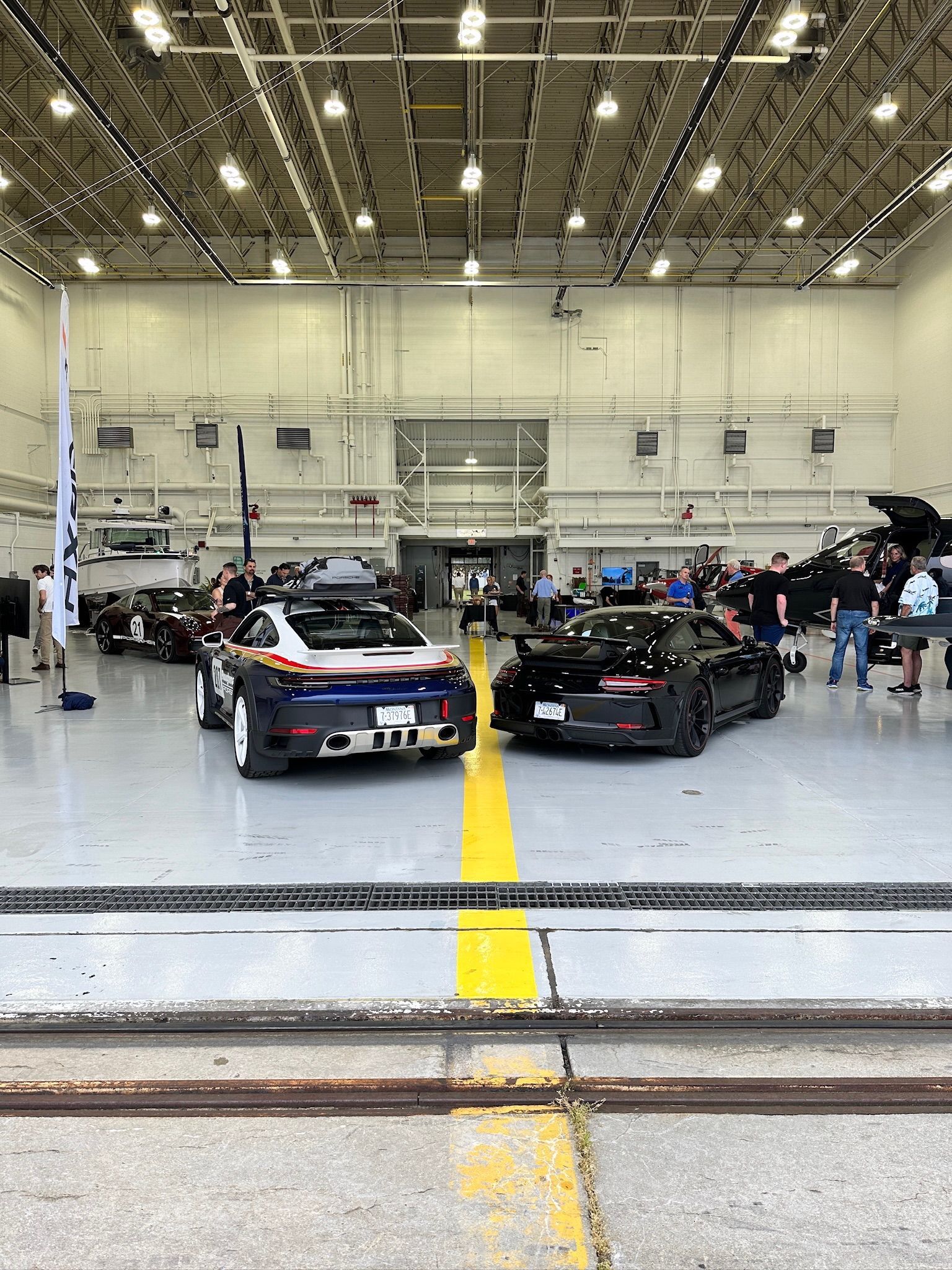 A group of cars are parked in a large garage.