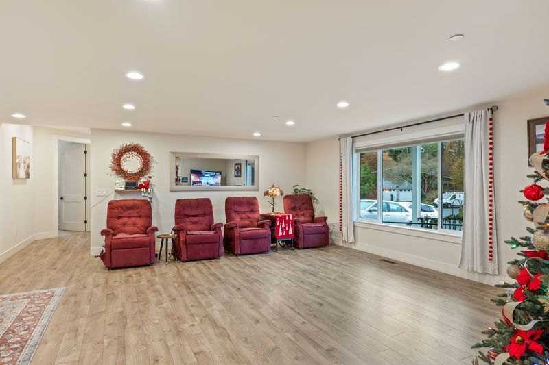 A living room filled with furniture and a christmas tree.