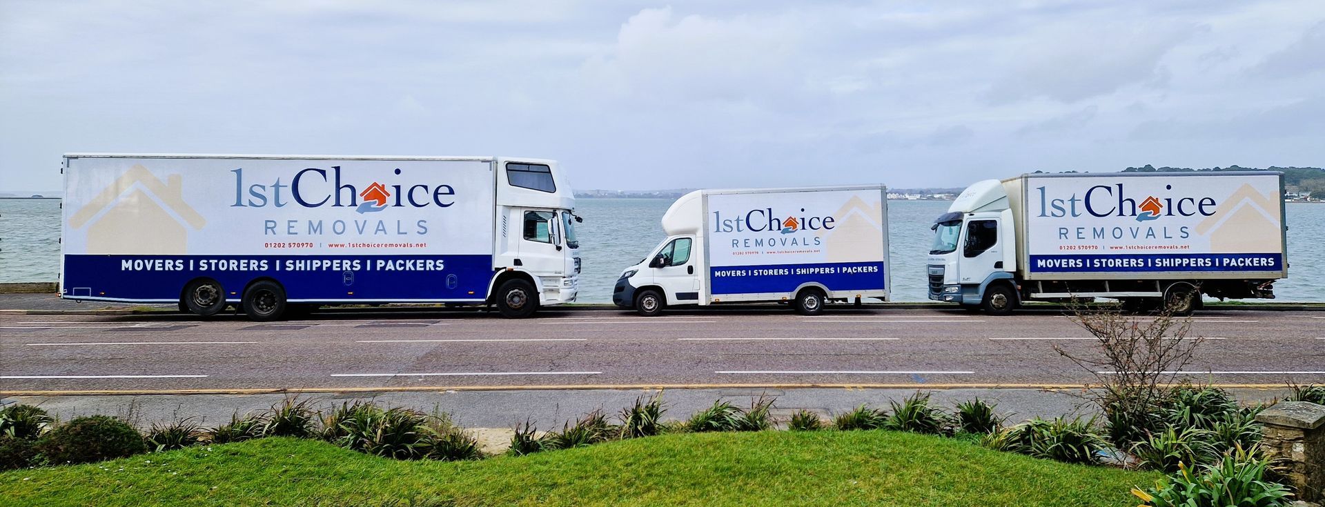Three 1st Choice Removals lorries parked on the seafront