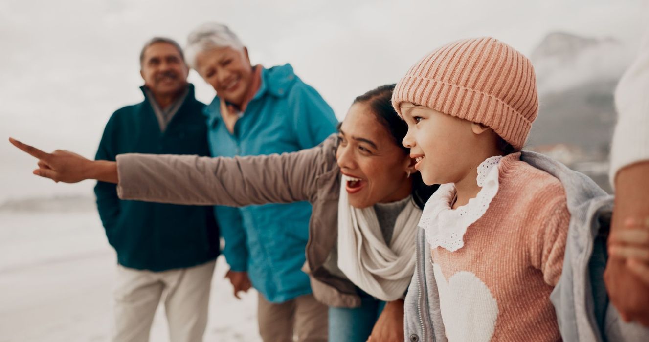 family enjoying beach outing together across generations