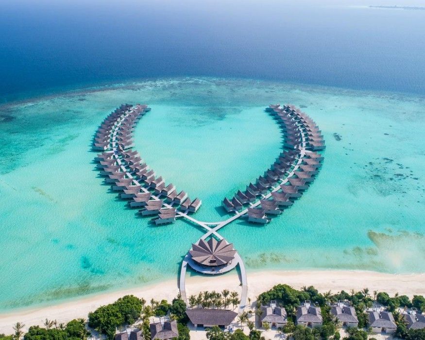 Overwater villas and island at Mövenpick Resort Kuredhivaru Maldives, a 5-star luxury resort ideal for First & Business Class Flight + Hotel holidays - xLuxuryFlights.com