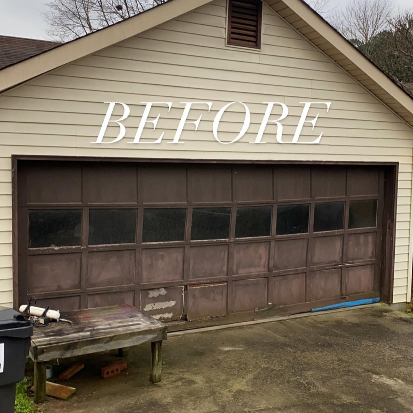 Before photo of a tan garage with a weathered brown door and cracked driveway