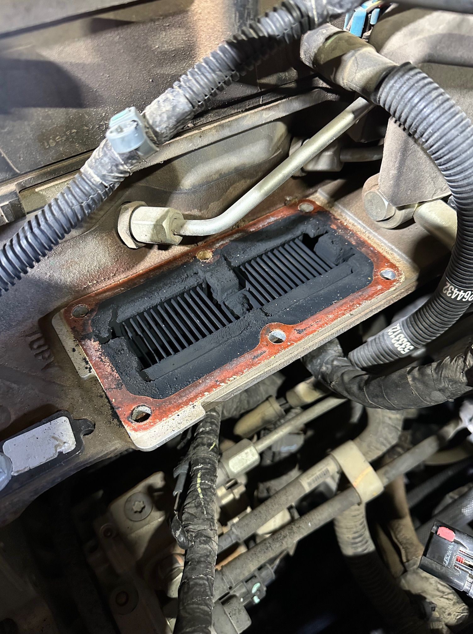 Open engine control module with wiring harnesses in a vehicle engine bay