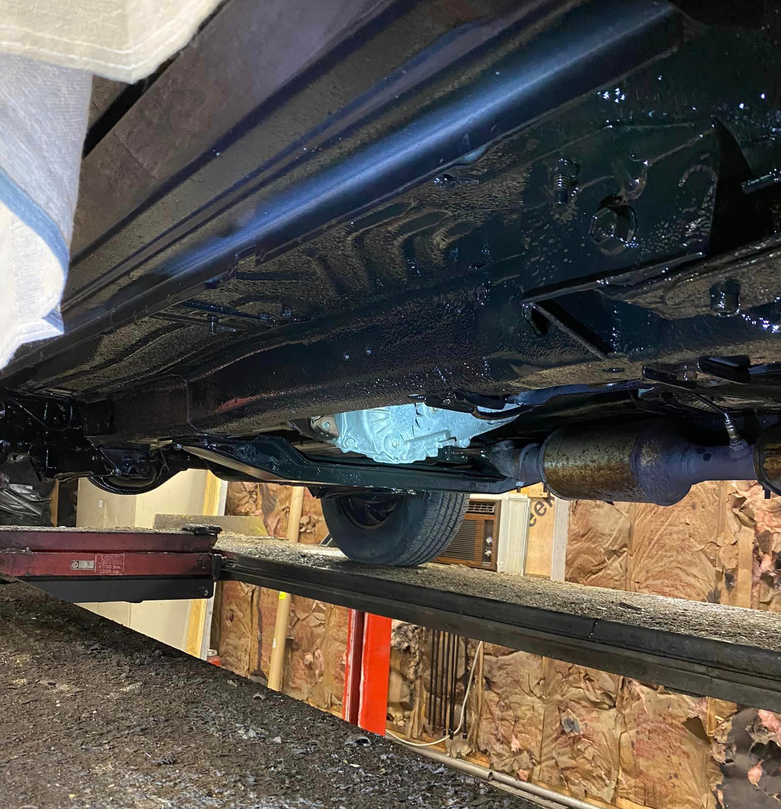 A car is sitting on a lift in a garage