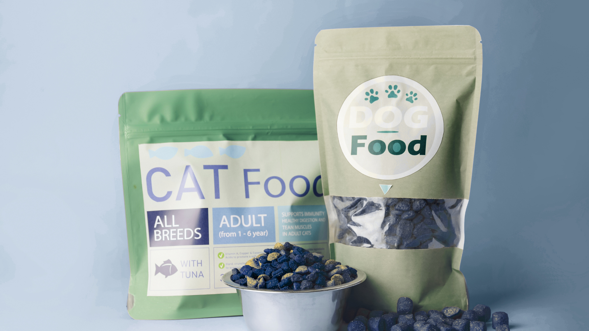 Two cat food bags with a bowl of kibble and blueberries on a light blue background