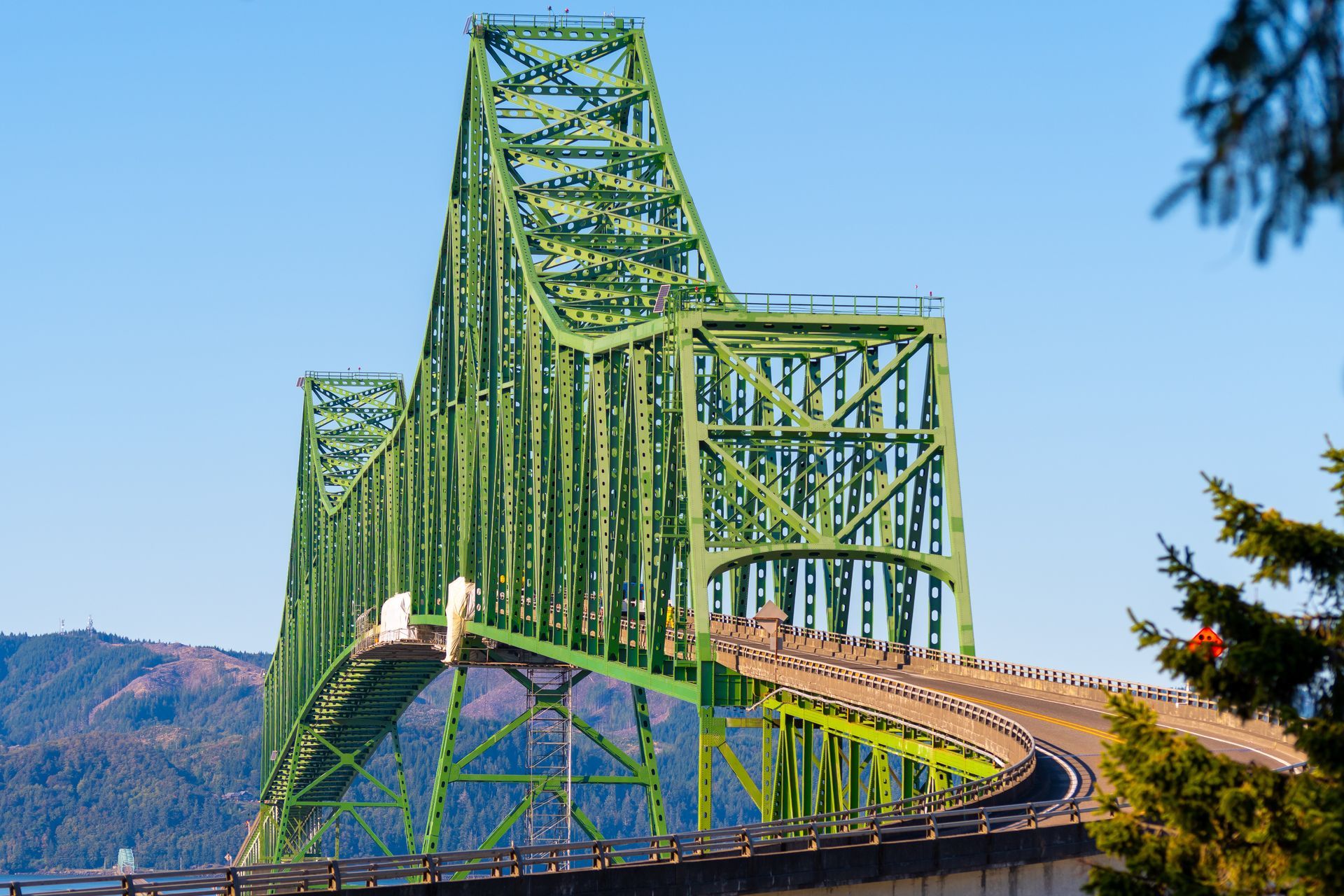 A green bridge with a blue sky in the background