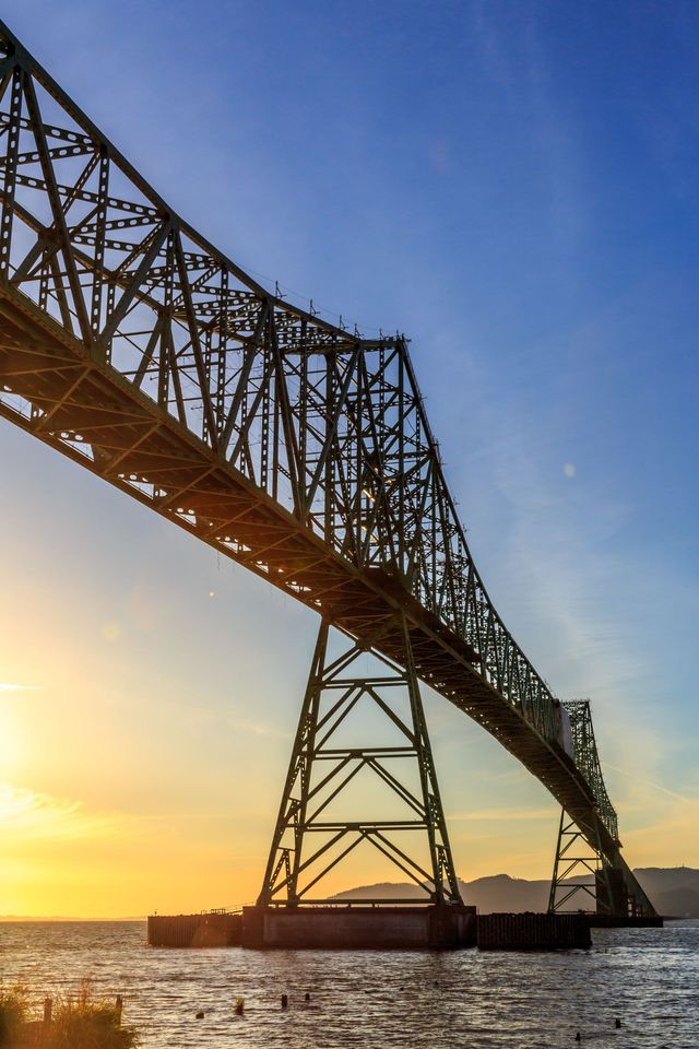 A bridge over a body of water at sunset