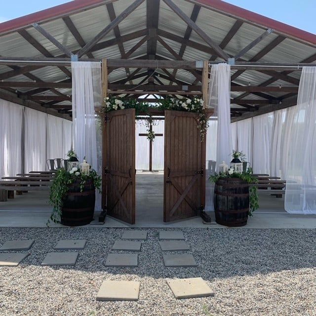 A church with barrels and flowers in front of it