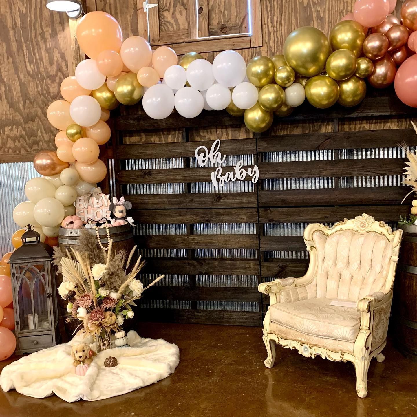 A wooden wall with balloons and a chair in front of it.