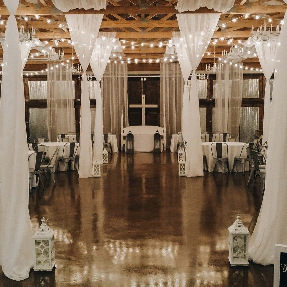 A large room with tables and chairs and lanterns
