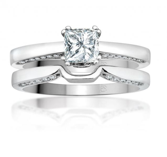 Diamond engagement ring set in white metal with a matching band on a white background