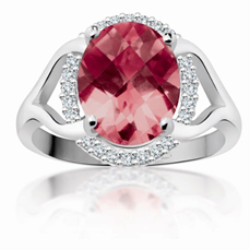 Oval pink gemstone ring with a silver band and small clear accent stones