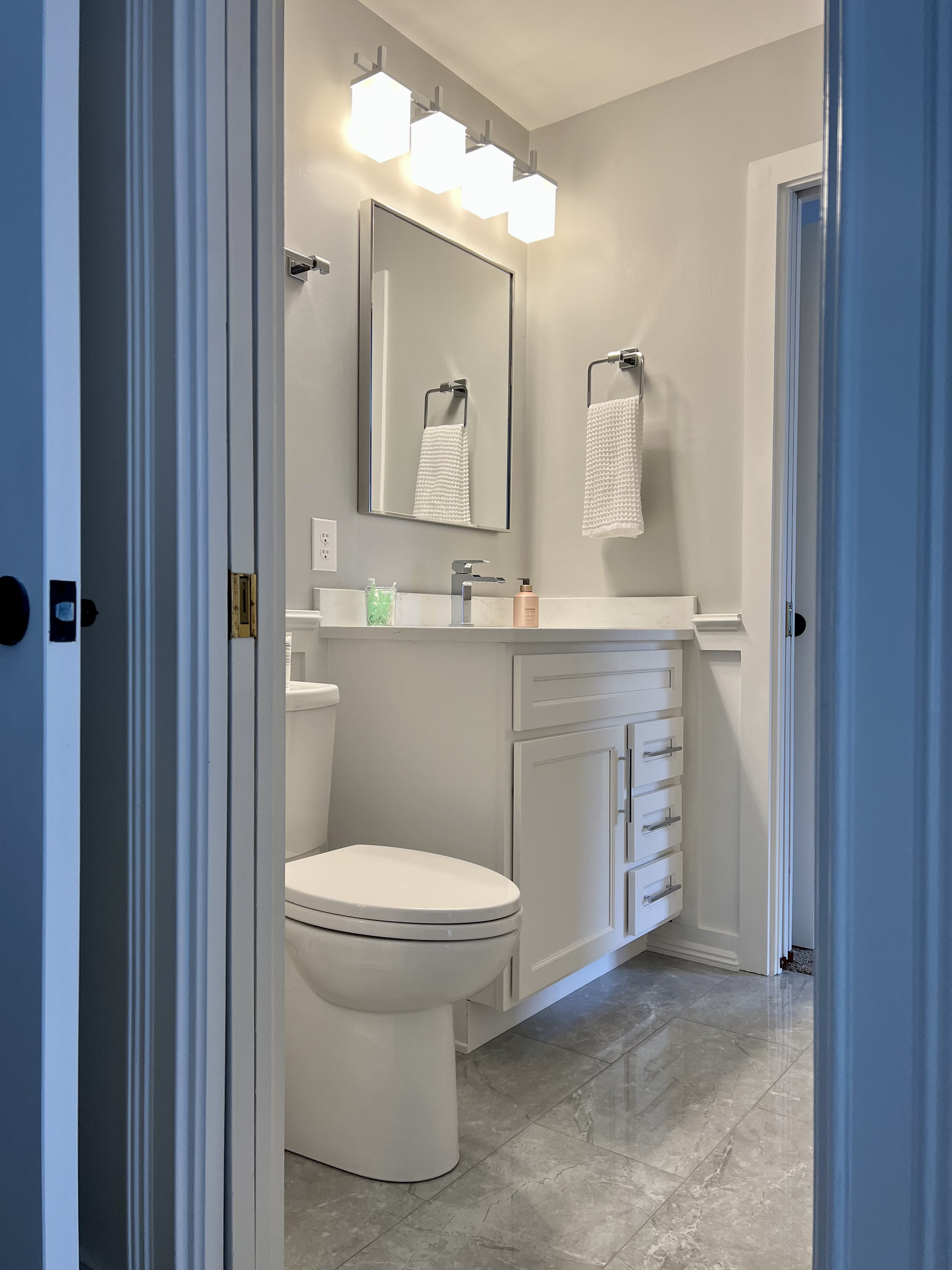 A bathroom with a toilet , sink and mirror