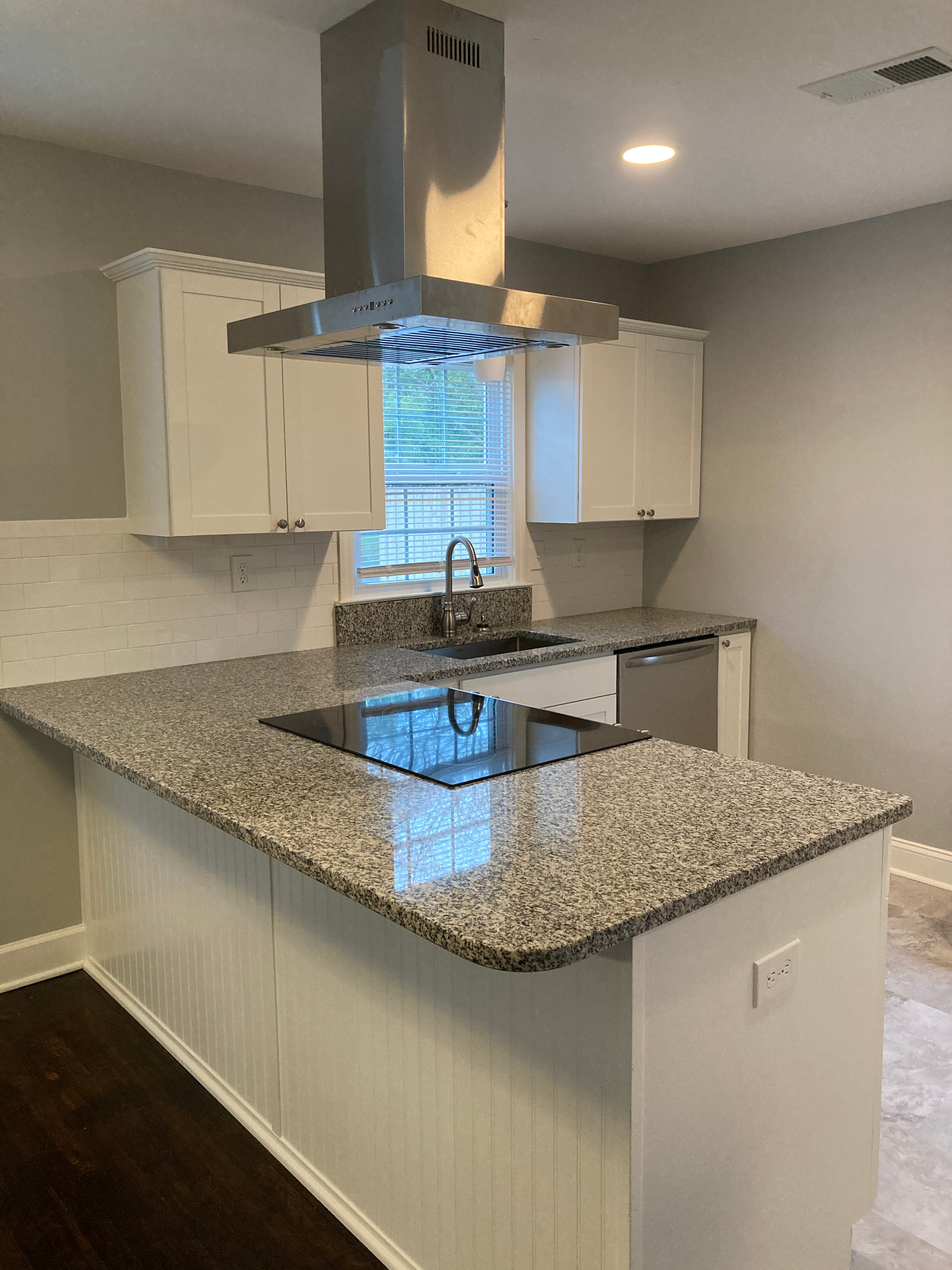 A kitchen with granite counter tops and stainless steel appliances