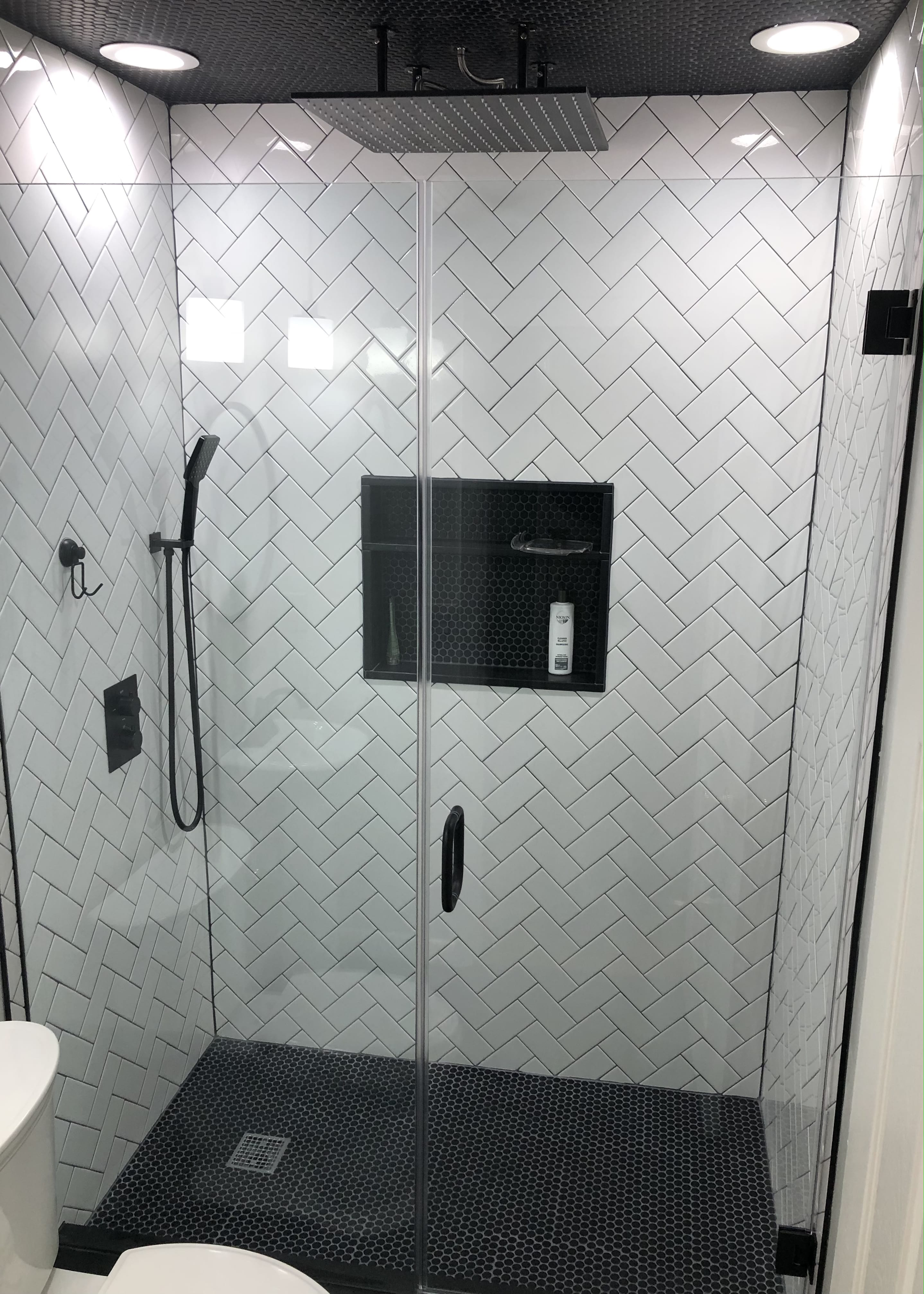 A bathroom with a walk in shower and a toilet.