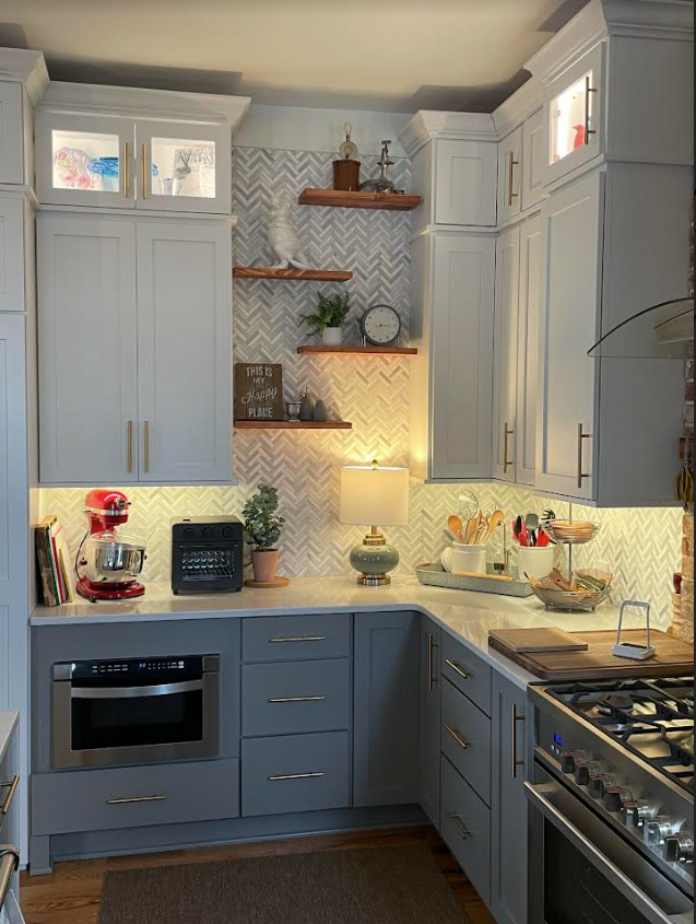 A kitchen with white cabinets and stainless steel appliances