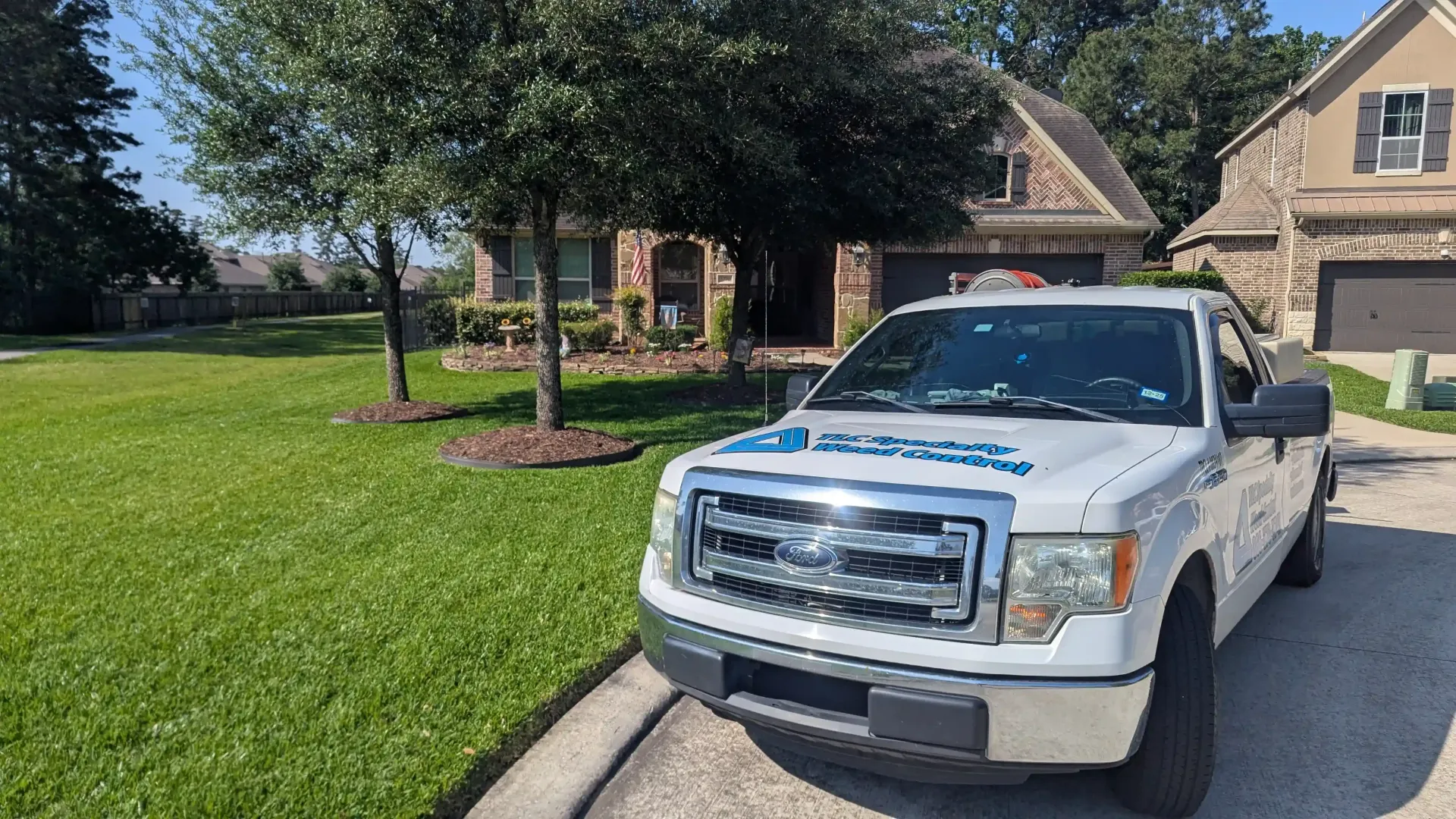 A white truck is parked in front of a house.
