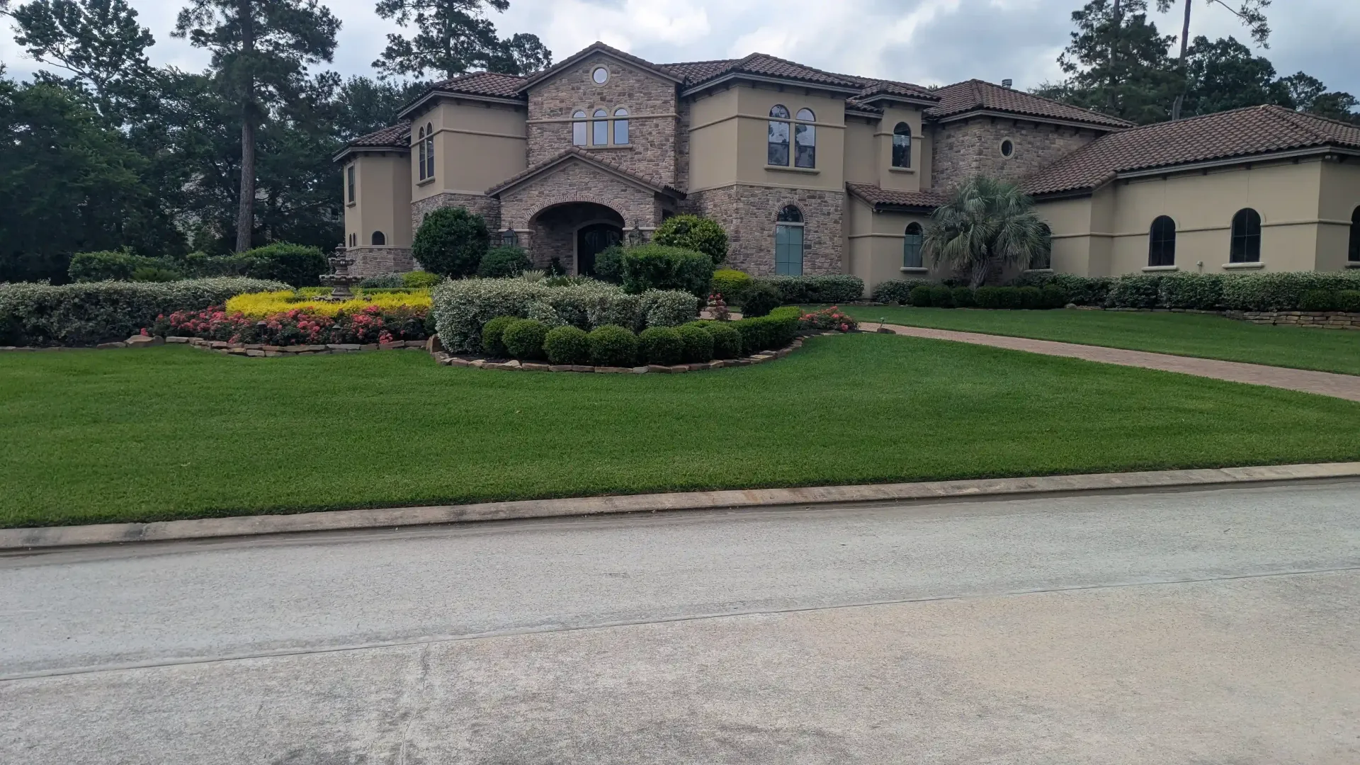 A large house with a lush green lawn in front of it