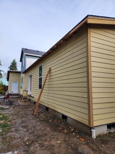 The side of a house is being painted yellow.