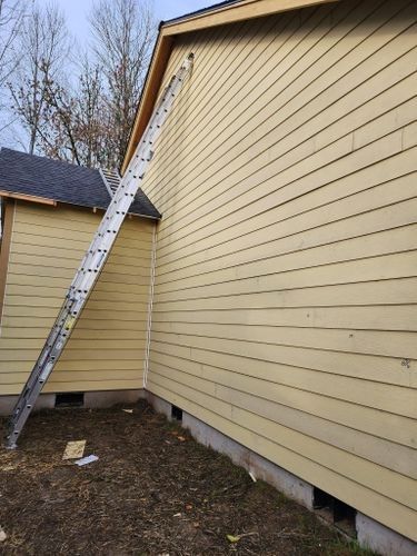 A ladder is leaning against the side of a house.