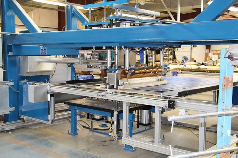 A machine is sitting on a table in a factory.