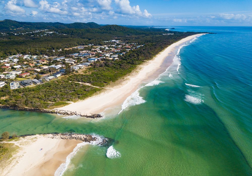 Aerial View of a Coastal Town With a Long Sandy Beach — Rob's Rubbish Removal in Pottsville, NSW