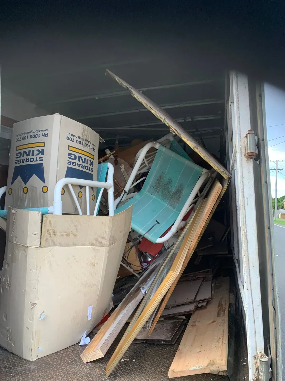 Pile of Junk is Sitting Inside of a Garage — Rob's Rubbish Removal in Tweed Heads West, NSW