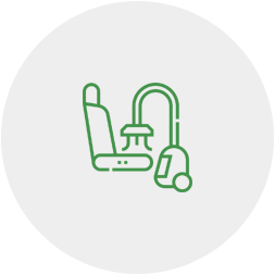 A green line icon of a vacuum cleaner and a seat.