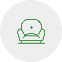 A green line drawing of a chair with a cross on it.
