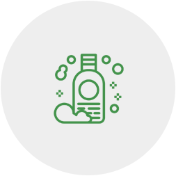 A green line icon of a bottle of soap with bubbles coming out of it.
