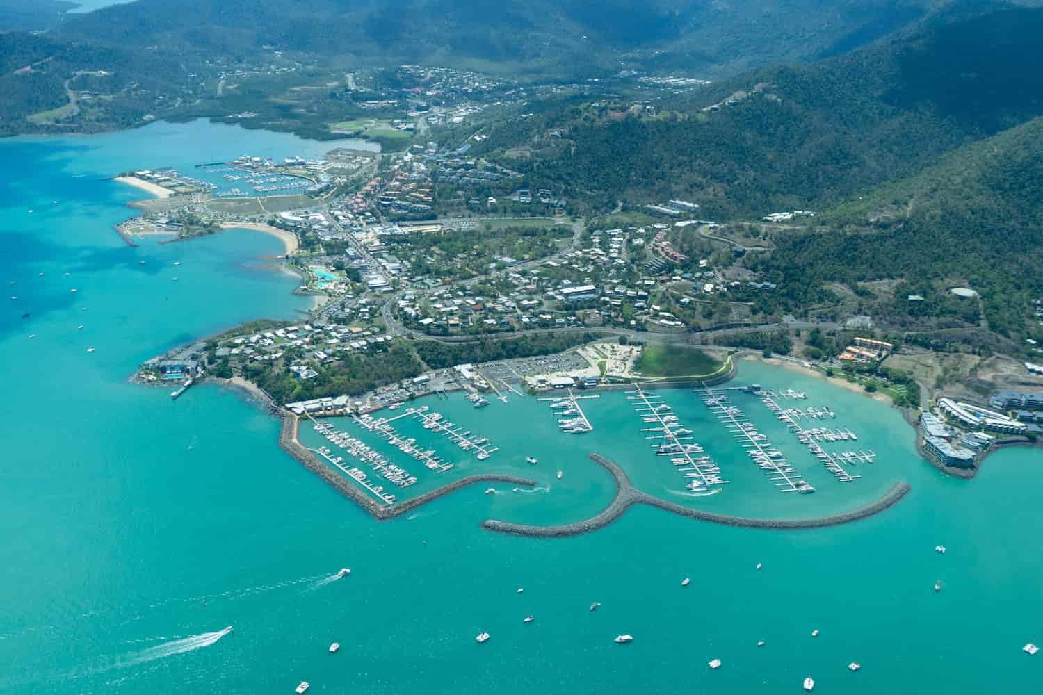 An Aerial View of a Harbor Filled With Boats and a City — East-West Fire Services In Airlie Beach, QLD