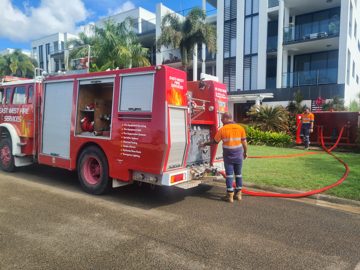 A Fire Truck is Parked on the Side of the Road Next to a Building — East-West Fire Services In Garbutt, QLD